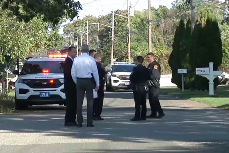 Police officers near the home of Rep. Lee Zeldin after a shooting in Long Island, N.Y., on Sunday.