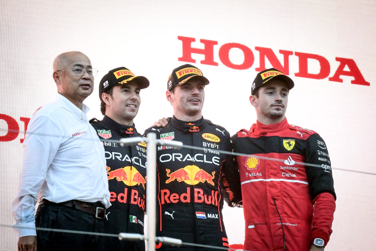 Image: Winner Red Bull Racing's Dutch driver Max Verstappen and teammate second-placed Red Bull Racing's Mexican driver Sergio Perez and third-placed Ferrari's Monegasque driver Charles Leclerc on the podium after the Formula One Japanese Grand Prix at Suzuka, Mie prefecture on Oct. 9, 2022.