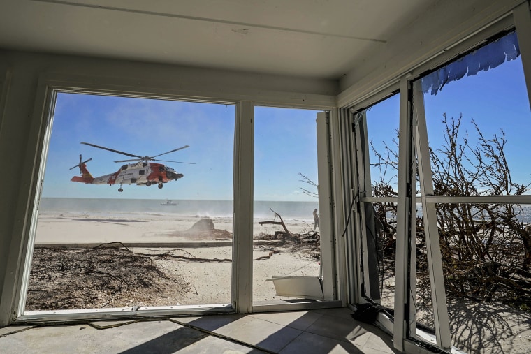 Image: A U.S. Coast Guard helicopter takes off, seen from inside a home damaged by Hurricane Ian on Sanibel Island, Fla., on Sept. 30, 2022.