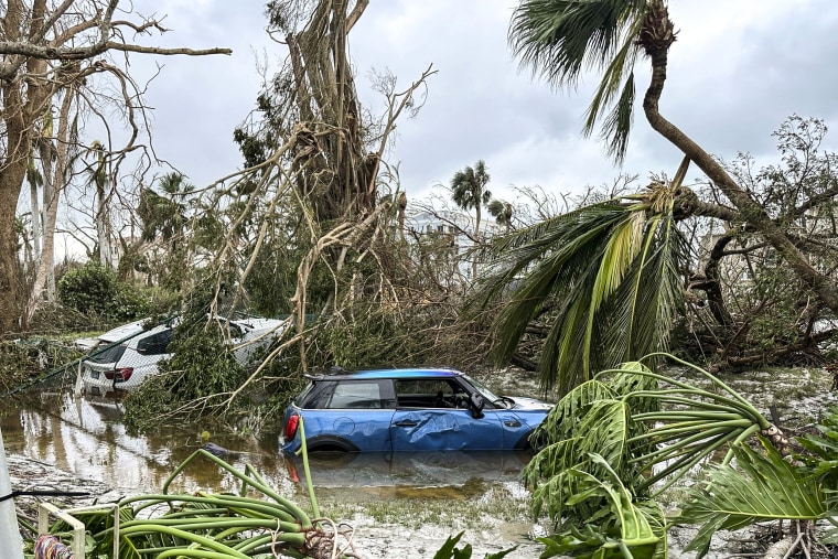 Image: Damaged vehicles and debris are seen on Sanibel Island, Fla., during Hurricane Ian.