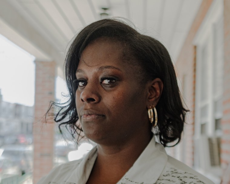 Portrait of April Lee in front at her home in Philadelphia.