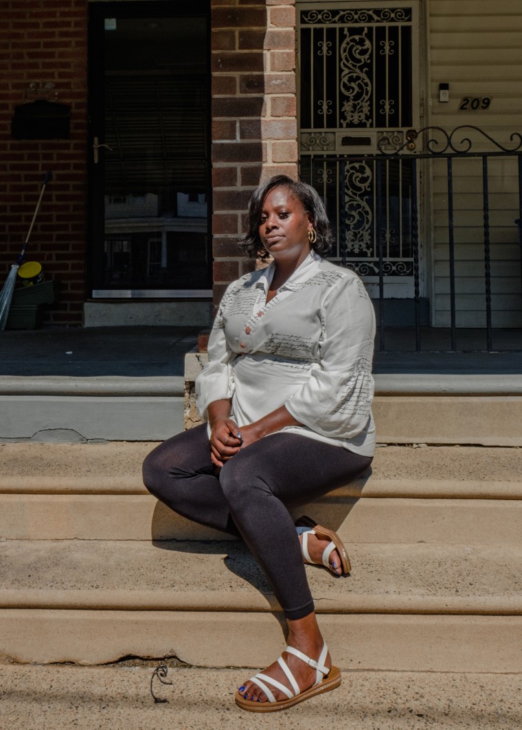 Portrait of April Lee in front of her home in Philadelphia.