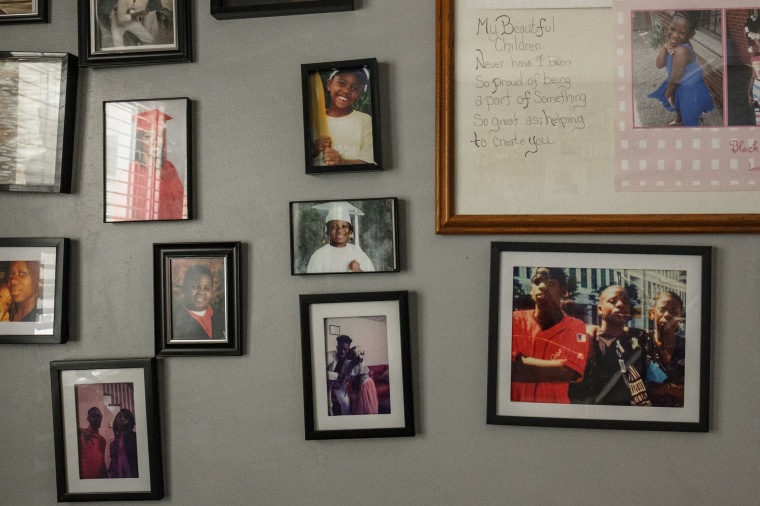 A wall of family photos in April Lee's home.