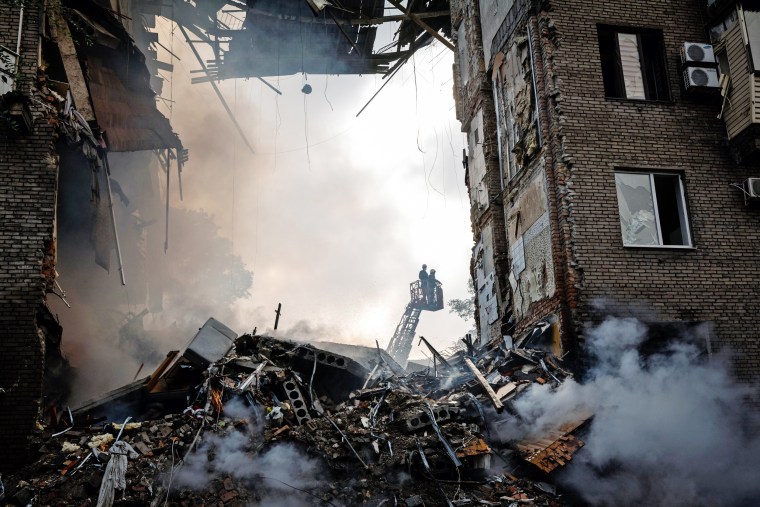 Image: Emergency workers at the scene of a Russian missile strike on Zaporizhzhia, Ukraine, on Monday, Oct. 10, 2022.