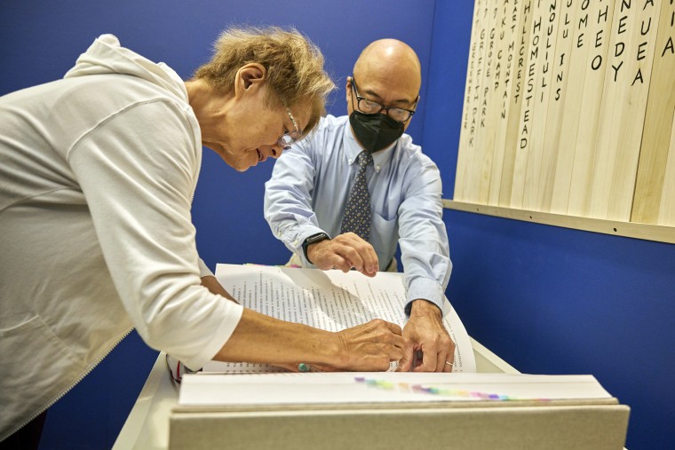 Sharon Yukiye Wu stamps a blue seal in the Ireichō.