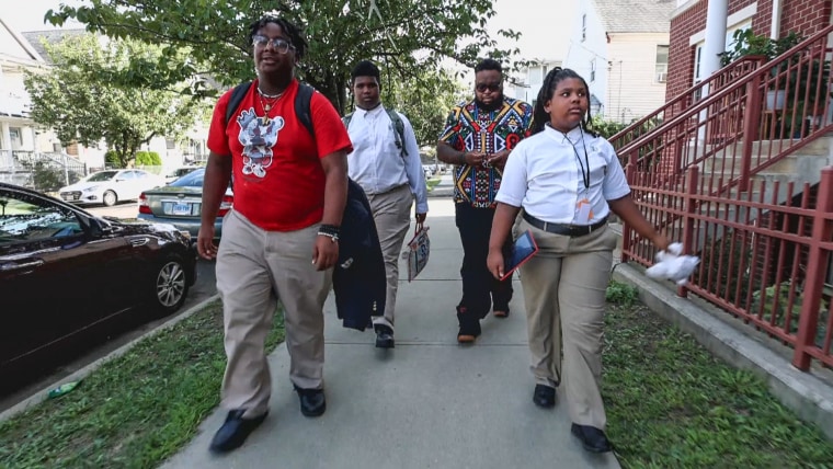 Tai Thergood and his children Taizir, left, Tajh, cetner, and Taraji walking home from school.