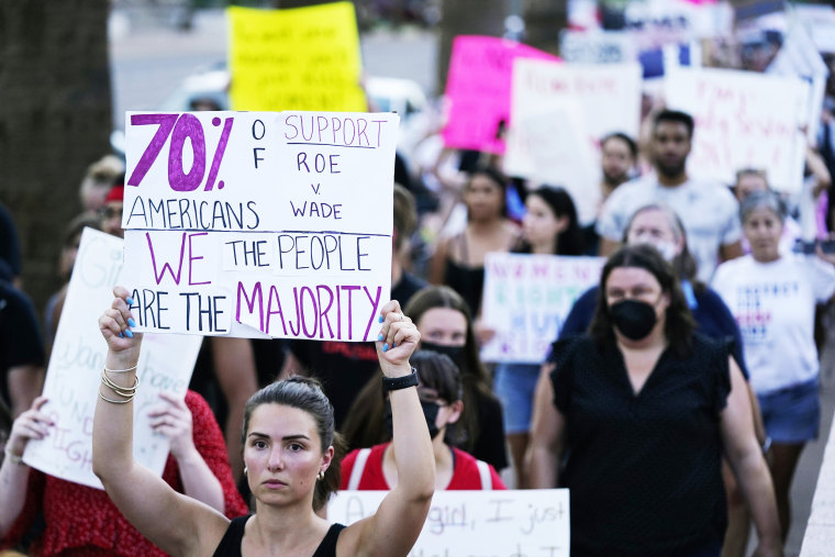 Abortion rights demonstrators march near the Arizona Capitol
