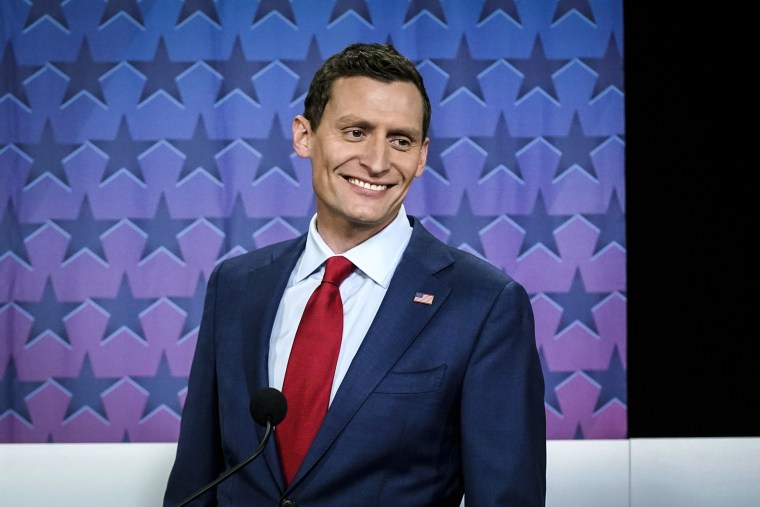 Image: Republican Senate challenger Blake Masters smiles on stage prior to a televised debate with Arizona Democratic Sen. Mark Kelly and Libertarian candidate Marc Victor in Phoenix on Oct. 6, 2022.