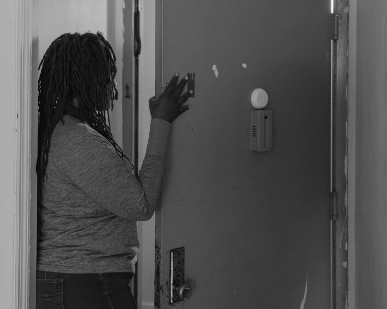 Ronisha Ferguson at the front door of her apartment in the Bronx in 2019.