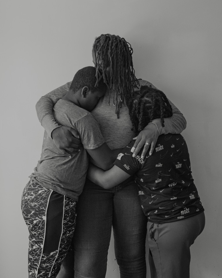 Portrait of Ronisha and her sons in embrace.