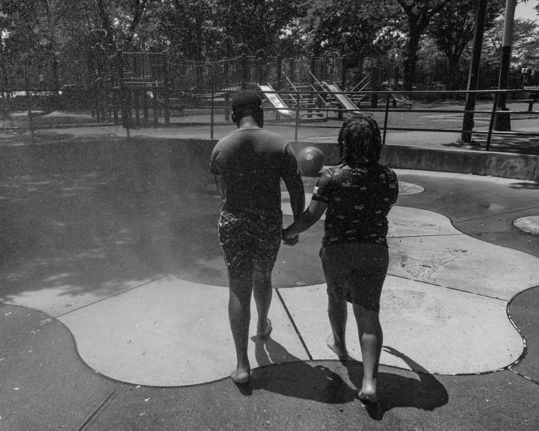 Ronisha's sons playing in the sprinklers at park near their home.