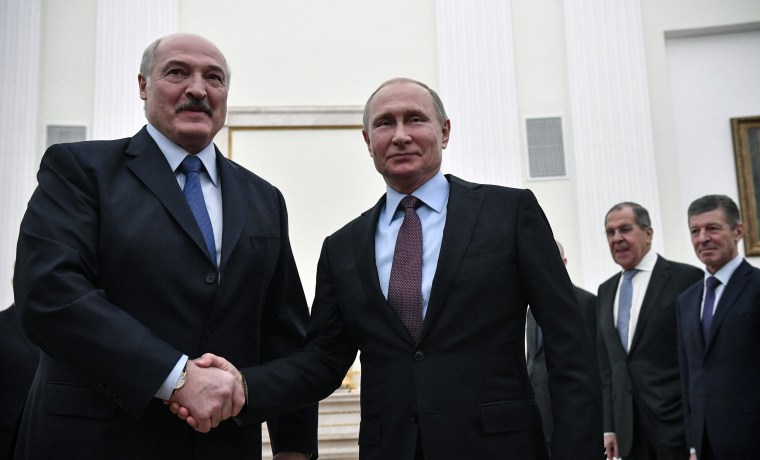 Alexander Lukashenko and Vladimir Putin shake hands during a meeting at the Kremlin in Moscow