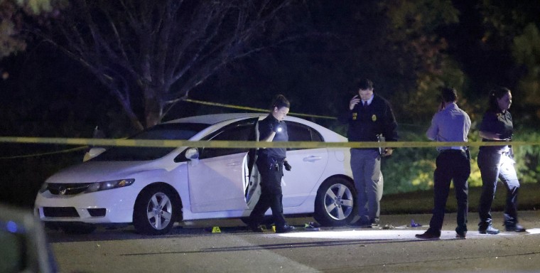 Police work a shooting scene on Osprey Cove Drive in the Hedingham neighborhood in Raleigh
