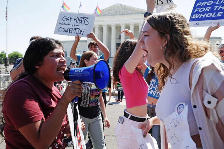 An abortion-rights activist argues with an anti-abortion activist in front of the Supreme Court on June 25, 2022.