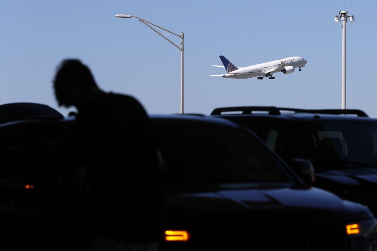 A passenger is silhouetted as a United Airlines plane takes off at O'Hare International Airport in Chicago on July 1, 2021. United Airlines said Wednesday, July 20, 2022, that it earned $329 million in the second quarter as summer vacationers packed planes, but the results fell far short of Wall Street expectations due largely to soaring fuel prices.
