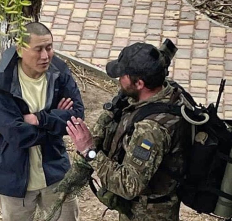 Grady Kurpasi speaks to a Ukrainian soldier in Kyiv in early April. He would go missing outside Kherson later that month.