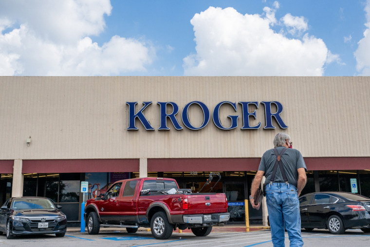 A customer walks into a Kroger grocery store, in Houston, Texas