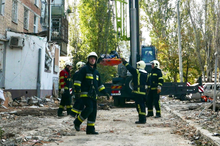 A body is recovered from the rubble by members of the Ukrainian emergency services. 