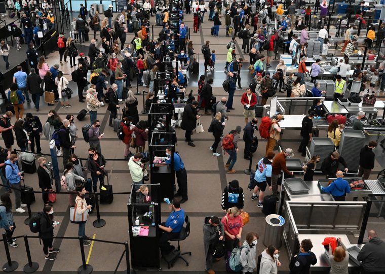 Long lines of travelers making their way through TSA security at Denver International Airport the day before Thanksgiving in 2021.