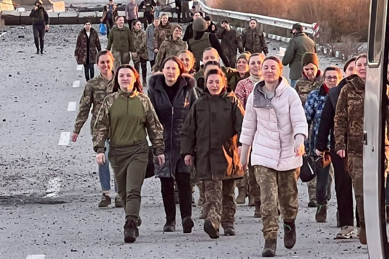 Ukrainian female prisoners of war walk together after being released in a prisoner exchange in an unknown location in Ukraine on Monday.