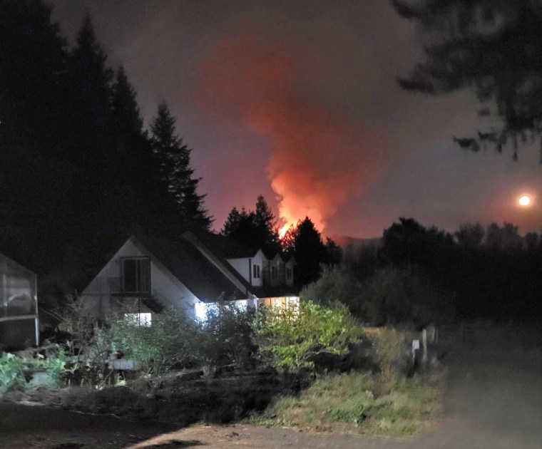 A wildfire burns the Conway family farm in Camas, Wash.