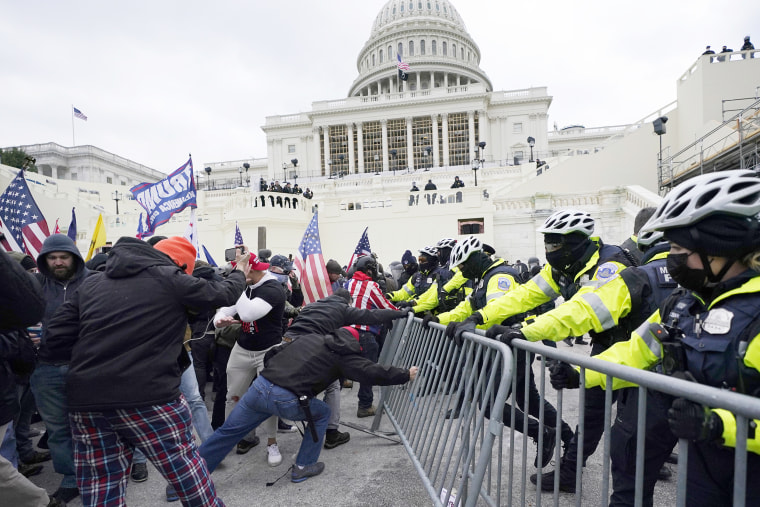 Insurrectionists loyal to President Donald Trump try to break through a police barrier, Wednesday, Jan. 6, 2021, at the Capitol in Washington. Facing prison time and dire personal consequences for storming the U.S. Capitol, some Jan. 6 defendants are trying to profit from their participation in the deadly riot, using it as a platform to drum up cash, promote business endeavors and boost social media profiles.
