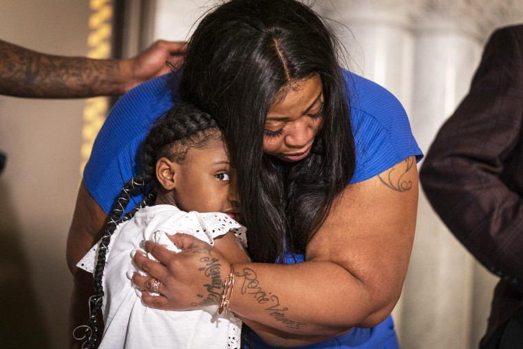 George Floyd's daughter Gianna Floyd gives her mother Roxie Washington a hug during a press conference