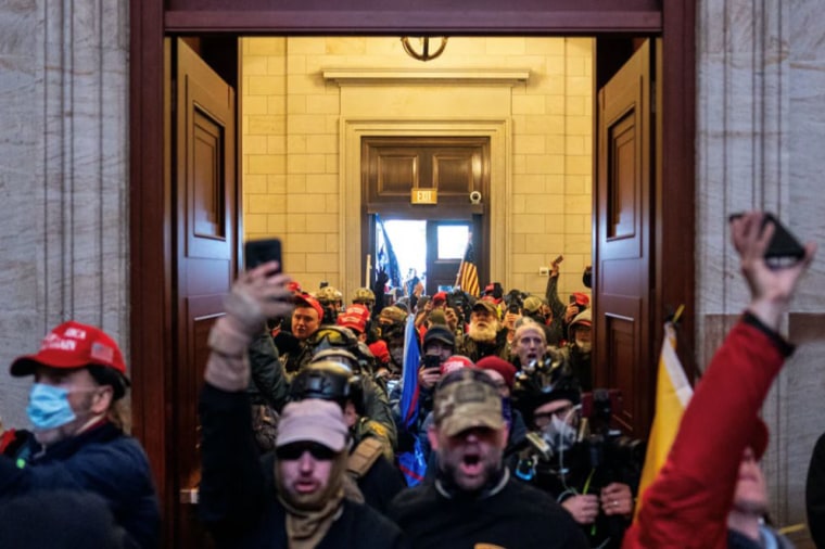 Jason Dolan, second left, at the Capitol on Jan. 6, 2021.