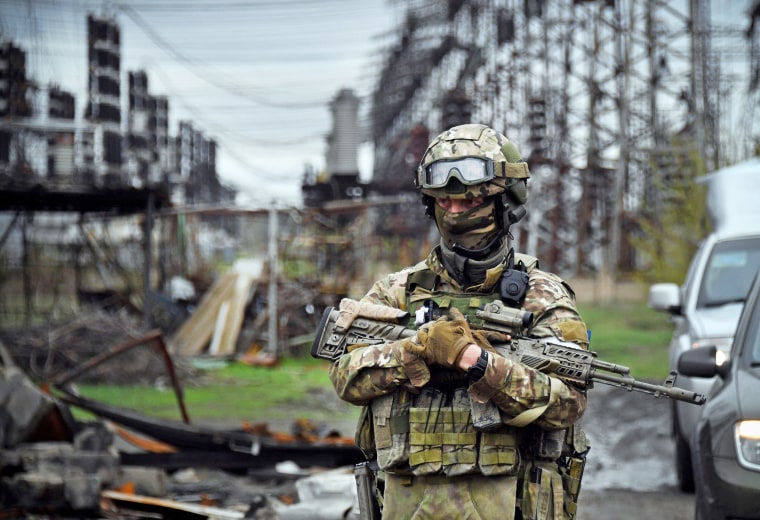 A Russian soldier stands guard at the Luhansk power plant in the town of Shchastya
