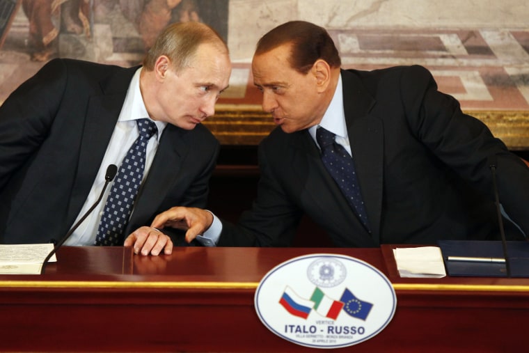 Vladimir Putin and Silvio Berlusconi talk at a news conference outside Milan in 2010. 