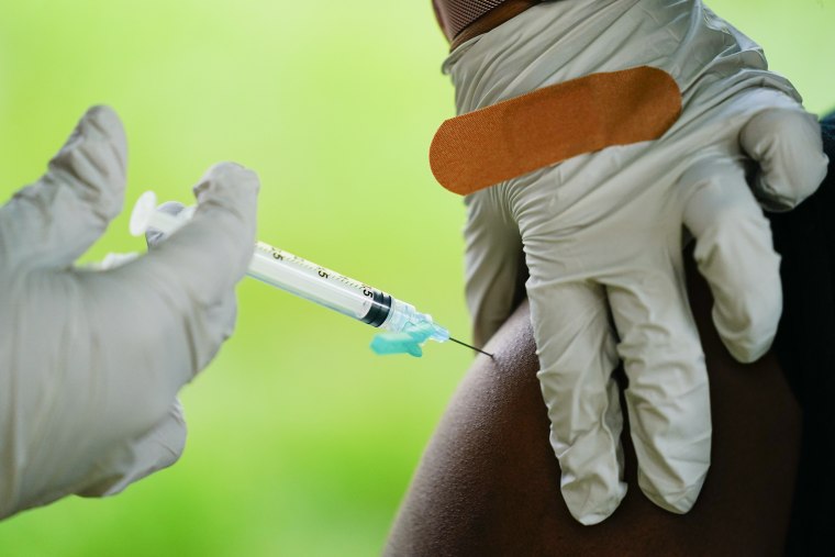 A health worker administers a dose of a Pfizer COVID-19 vaccine in Reading, Pa.