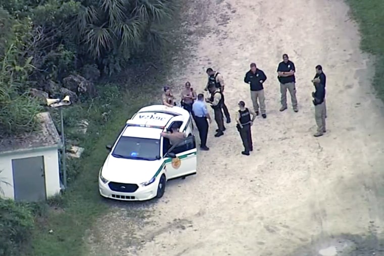 Law enforcement officers investigate the death of a Customs and Border Protection officer who was shot Wednesday at a gun range in Miami-Dade County.