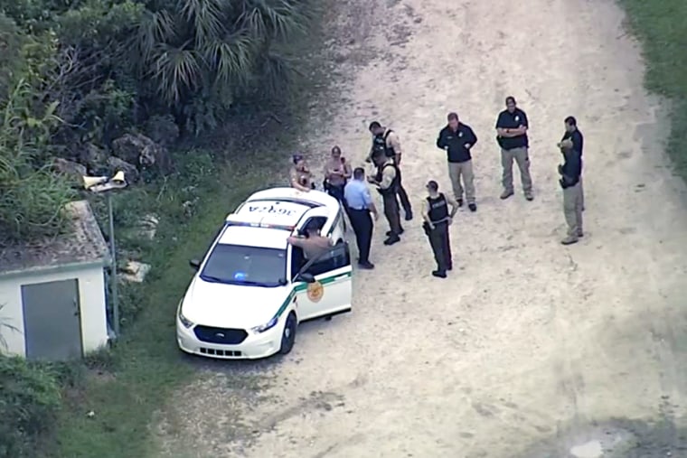 Law enforcement officers investigate the death of a U.S. Customs and Border Protection officer after he was shot Wednesday at a gun range in Miami-Dade County.