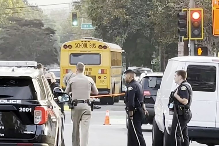 Police investigate the scene of a school bus accident that killed San Jose State football player Camdan McWright while he was riding an electric scooter, on Friday.
