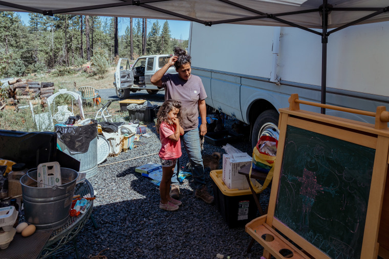 Salinas and her daughter River outside their temporary trailer home.