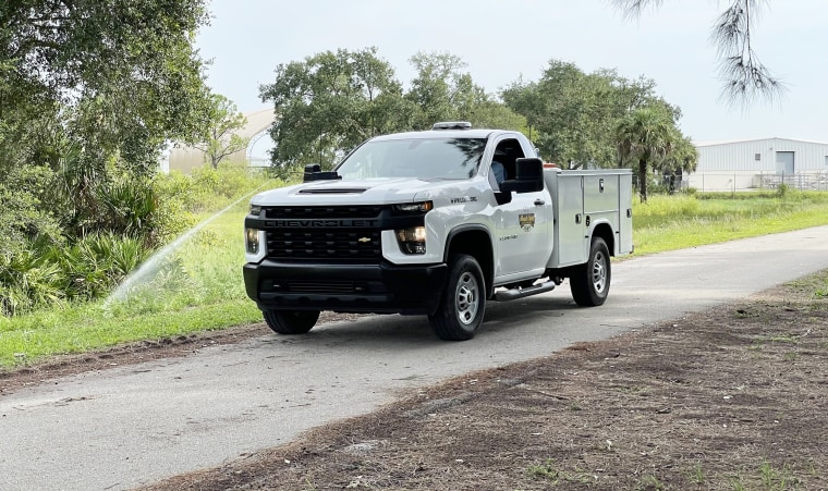 A truck sprays larvicide into a ditch