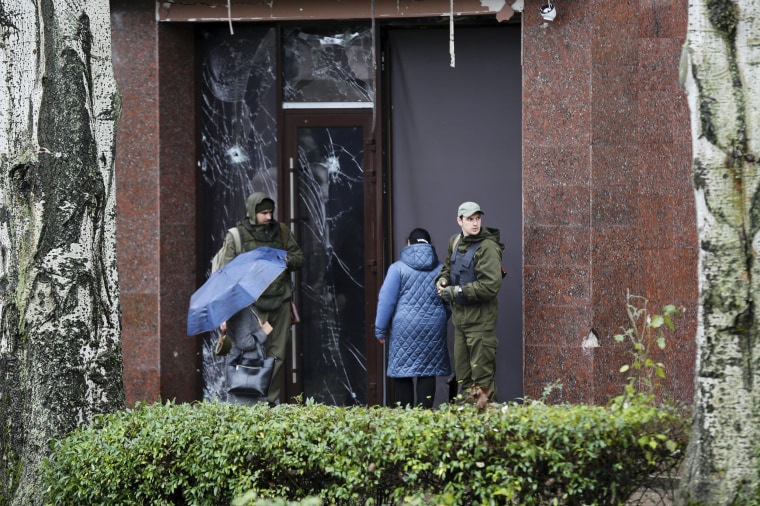 Soldiers guard the entrance of a government building in Donetsk, the capital of the self-proclaimed Donetsk People's Republic in eastern Ukraine on Oct. 20, 2022. 