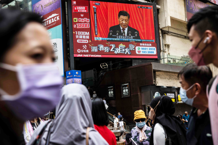 A telecast of Chinese President Xi Jinping plays on a screen in a street in Hong Kong