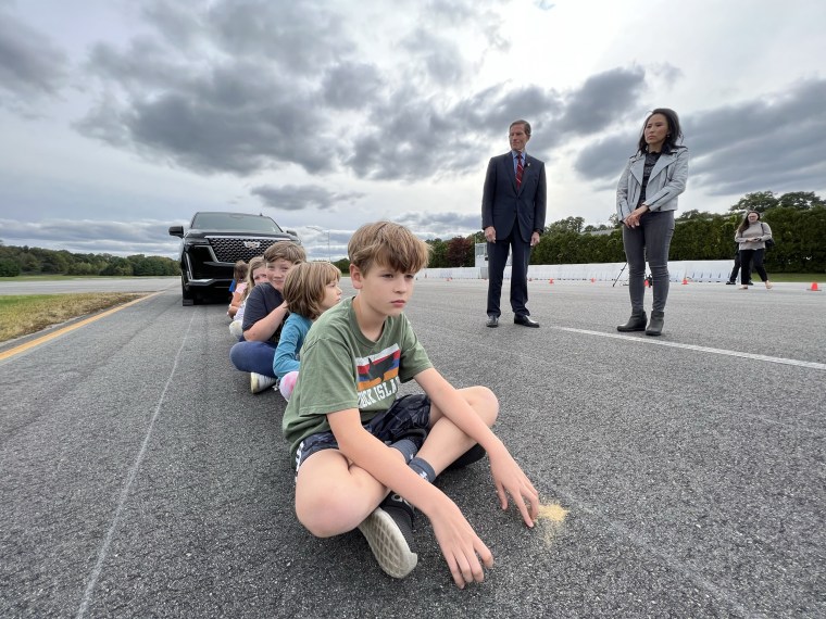 A group of elementary school children sit during a SUV visibility test conducted by NBC News.
