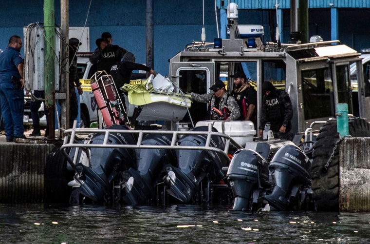 Costa Rica's Coast Guard personnel unload debris found during the search for a small plane that crashed off the coast in Limon on Oct. 22, 2022.