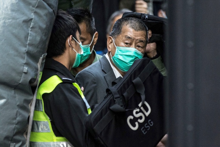 This file photo taken on February 1, 2021 shows Hong Kong media tycoon Jimmy Lai (R) being escorted into a Hong Kong Correctional Services van outside the Court of Final Appeal after being ordered to remain in jail while judges consider his fresh bail application. - Lai was among three democracy campaigners convicted on December 9, 2021 for taking part in a banned Tiananmen vigil as the prosecution of multiple activists came to a conclusion.