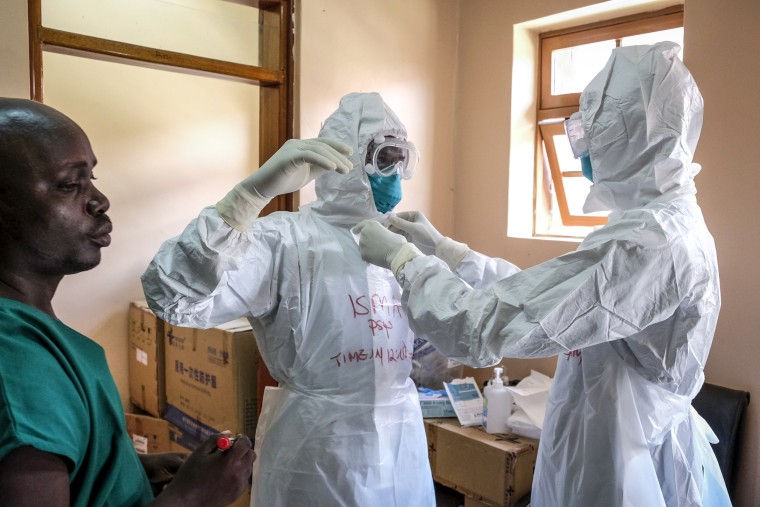 Image: Doctors put on protective equipment as they prepare to visit a patient who was in contact with an Ebola victim, in the isolation section of Entebbe Regional Referral Hospital in Entebbe, Uganda on Oct. 20, 2022.