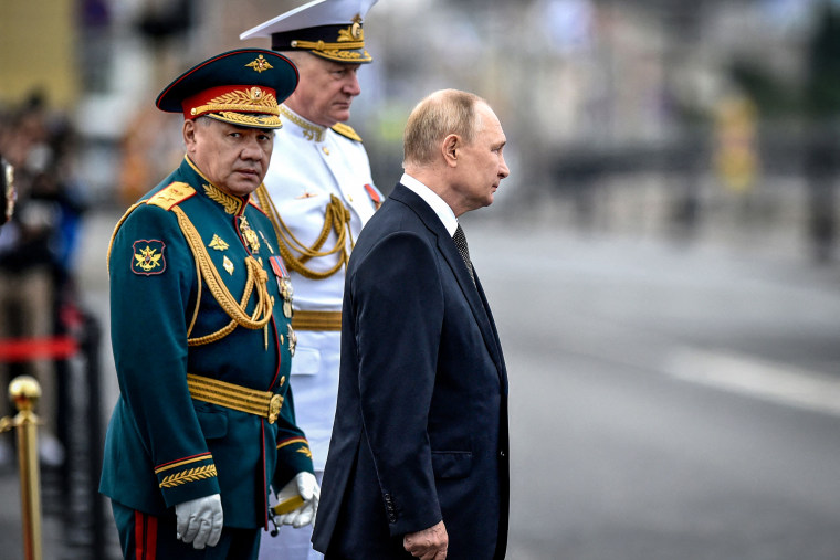 Russia's President Vladimir Putin flanked by Russia's Defence Minister Sergei Shoigu, left, and Commander-in-Chief of the Russian Navy, Admiral Nikolai Yevmenov, center, attends the main naval parade marking the Russian Navy Day, in St. Petersburg on July 31, 2022.