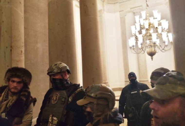 Harry Dunn, third right, surrounded by Oath Keepers in a photo presented as evidence in the Oath Keepers trial.