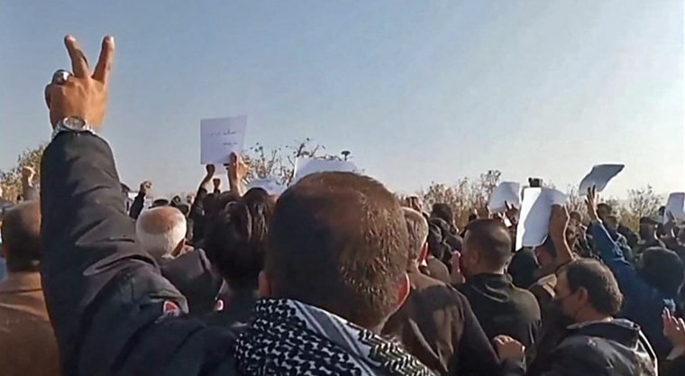 Iranian mourners march towards Aichi cemetery in Saqez, to mark 40 days since Mahsa Amini's death, on Oct. 26, 2022.