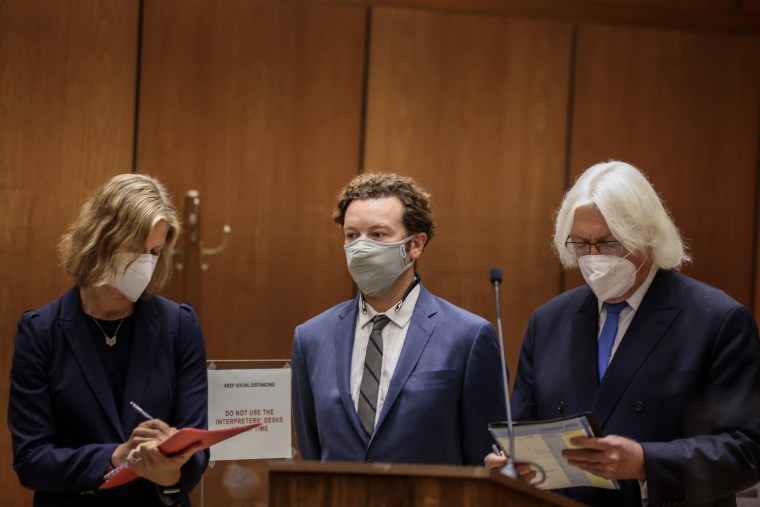 Image: Actor Danny Masterson stands with his attorneys as he is arraigned on three rape charges on September 18, 2020 in Los Angeles, California.