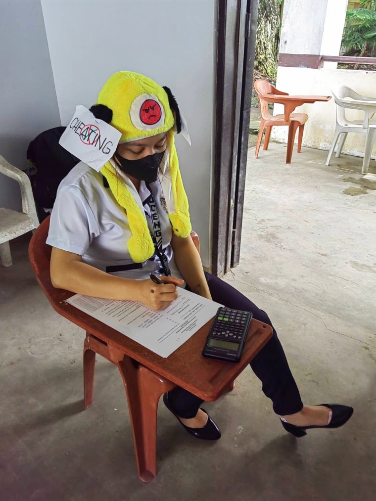 Students at Bicol University College of Engineering in Legazpi City, the Philippines, take an exam on Oct. 17, 2022, while wearing 'anti-cheating hats' they designed as part of an assignment