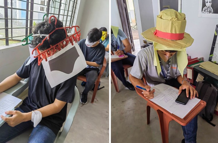 Students at Bicol University College of Engineering in Legazpi City, the Philippines, take an exam on Oct. 17, 2022, while wearing 'anti-cheating hats' they designed as part of an assignment
