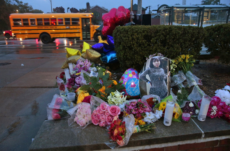 A photo of Alexzandria Bell sits among flowers and candles left as a memorial to the victims of a school shooting at Central Visual & Performing Arts High School on Oct. 25, 2022, in St. Louis.