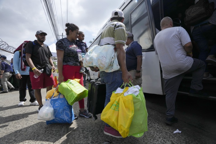 Venezuelan migrants board a bus in Panama City.